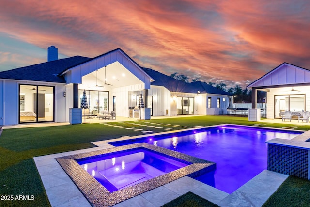 7851 N Central Ave, Phoenix, AZ 85020 - pool at dusk featuring ceiling fan, a yard, an outdoor living space, a patio area, and a pool with connected hot tub