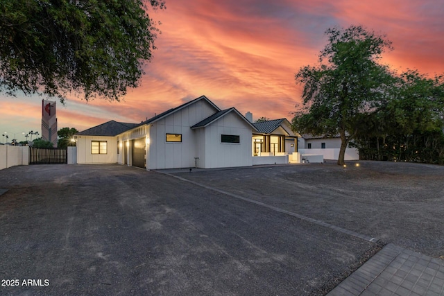 7851 N Central Ave, Phoenix, AZ 85020 - modern farmhouse style home with board and batten siding, a chimney, and a garage