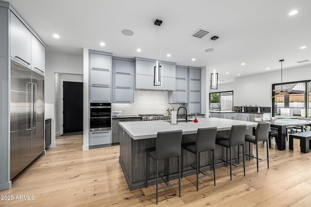 7851 N Central Ave, Phoenix, AZ 85020 - kitchen featuring stainless steel appliances, gray cabinetry, modern cabinets, and recessed lighting