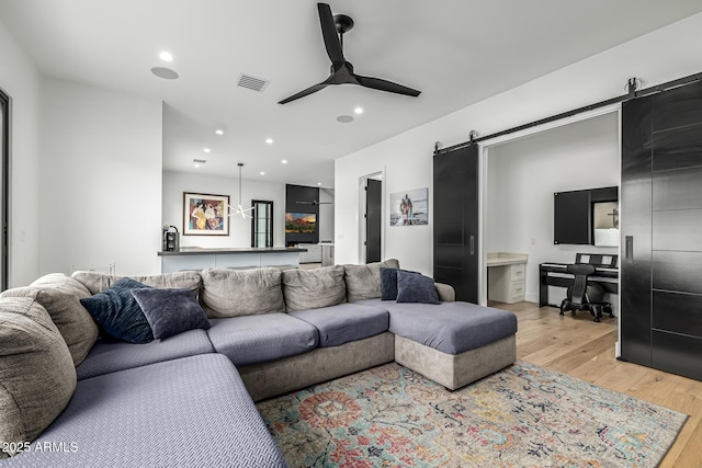 7851 N Central Ave, Phoenix, AZ 85020 - living area featuring a barn door, light wood finished floors, an office area, a ceiling fan, and recessed lighting
