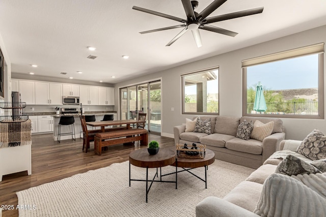 7858 W Fetlock Trl, Peoria, AZ 85383 - living room featuring wood finished floors, ceiling fan, and recessed lighting