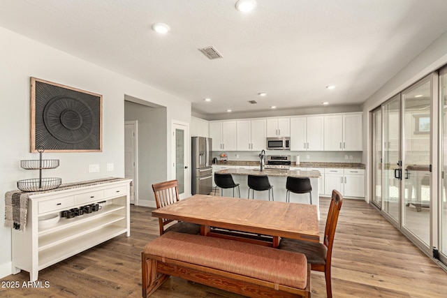 7858 W Fetlock Trl, Peoria, AZ 85383 - dining room with wood finished floors and recessed lighting