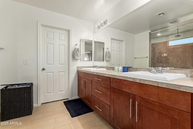 7858 W Fetlock Trl, Peoria, AZ 85383 - full bath with double vanity, a tile shower, and wood finished floors