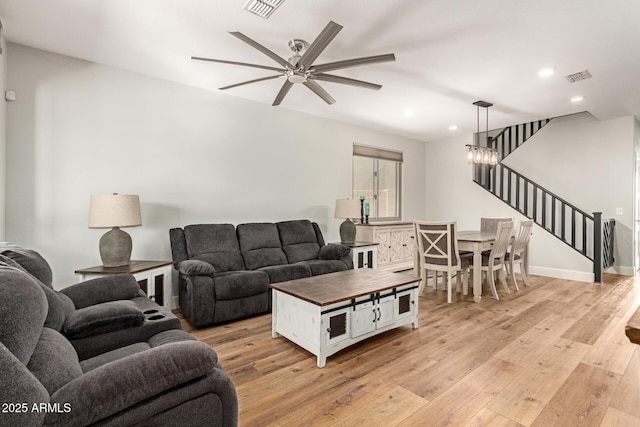 7858 W Fetlock Trl, Peoria, AZ 85383 - living room featuring light wood finished floors, stairway, ceiling fan, and recessed lighting