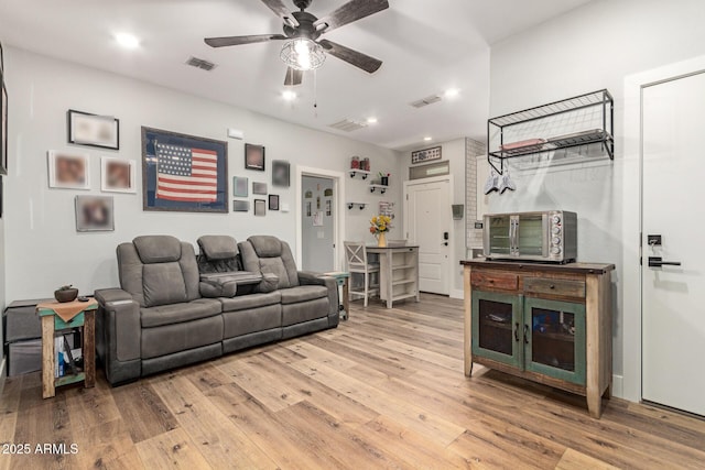 7858 W Fetlock Trl, Peoria, AZ 85383 - living room with light wood-style flooring, a ceiling fan, and recessed lighting