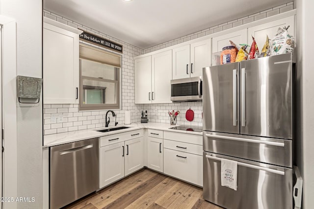 7858 W Fetlock Trl, Peoria, AZ 85383 - kitchen with stainless steel appliances, white cabinetry, wood finished floors, and backsplash