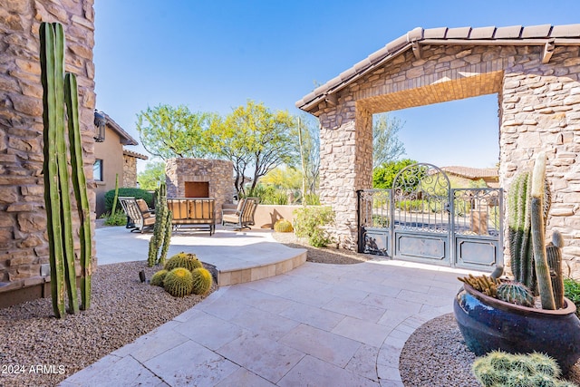 view of patio with an outdoor stone fireplace