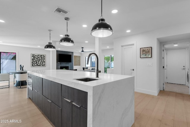 10360 N 98th St, Scottsdale, AZ 85258 - kitchen with visible vents, modern cabinets, a sink, recessed lighting, and light wood-style flooring