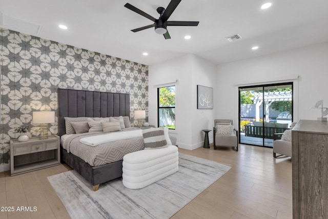 10360 N 98th St, Scottsdale, AZ 85258 - bedroom featuring multiple windows, wallpapered walls, access to exterior, and an accent wall