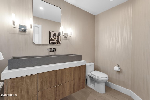 10360 N 98th St, Scottsdale, AZ 85258 - half bathroom featuring baseboards, wood finished floors, toilet, and vanity