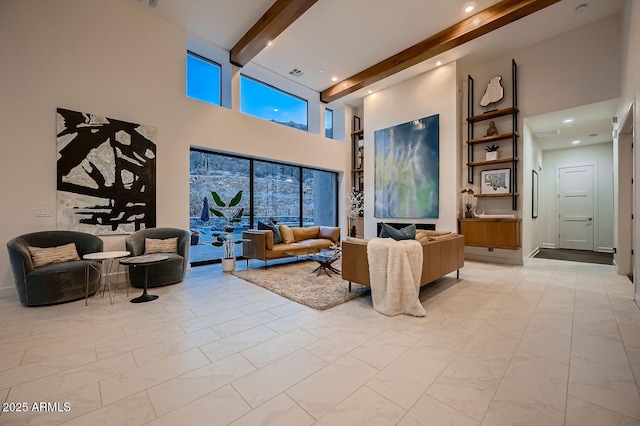 living room featuring a high ceiling and beam ceiling