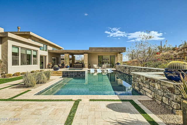 view of swimming pool with an in ground hot tub and a patio