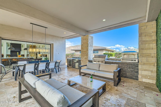 view of patio / terrace featuring exterior kitchen, outdoor lounge area, and a grill