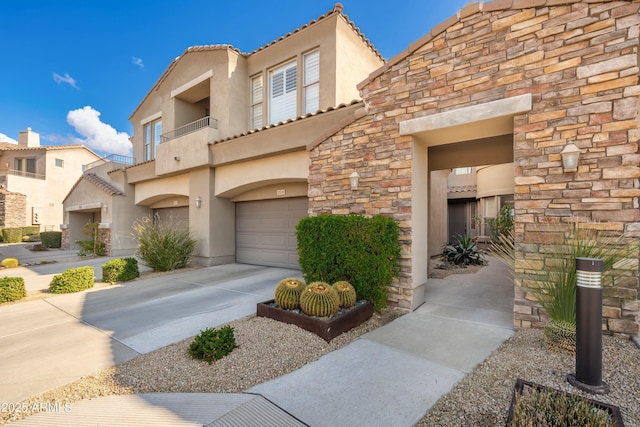 view of front of home with a garage and a balcony