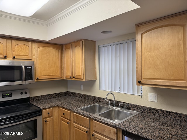 kitchen with stainless steel appliances, crown molding, sink, and dark stone countertops