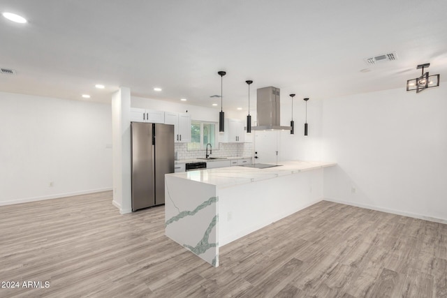 kitchen featuring stainless steel fridge, dishwashing machine, wall chimney range hood, decorative light fixtures, and white cabinets