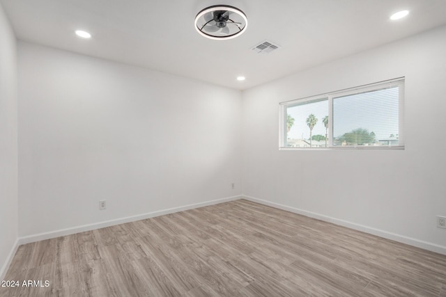 empty room with ceiling fan and light wood-type flooring