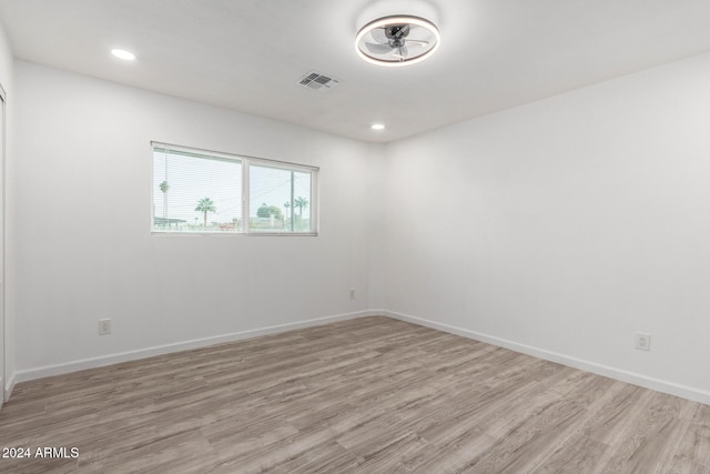 spare room with light hardwood / wood-style flooring