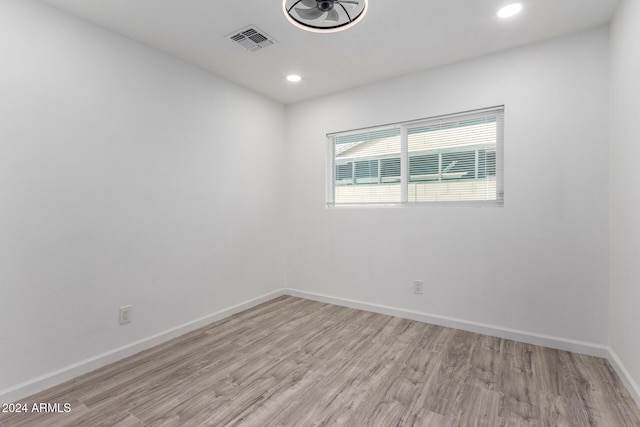 spare room featuring light hardwood / wood-style floors