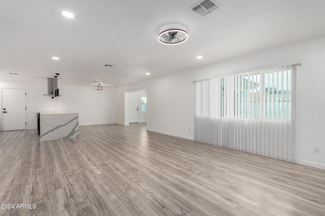 unfurnished living room featuring light wood-type flooring