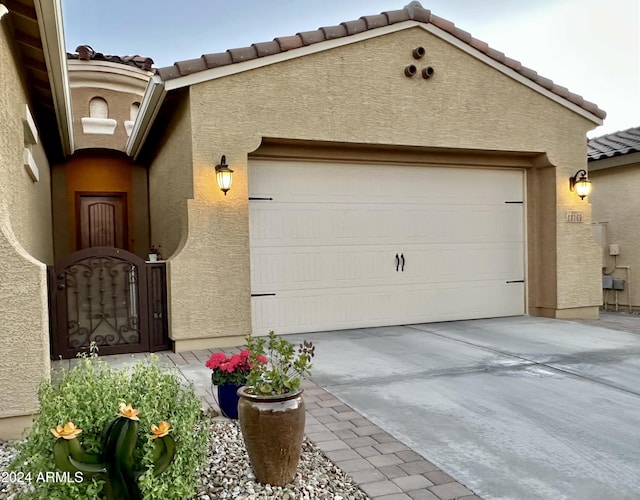 garage featuring concrete driveway