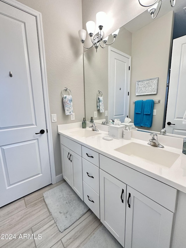 bathroom featuring an inviting chandelier and vanity