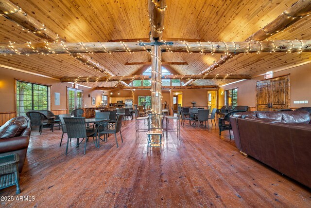 dining area with wood ceiling, lofted ceiling with beams, ceiling fan, and hardwood / wood-style floors