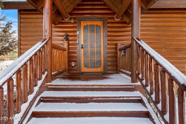 view of snow covered property entrance