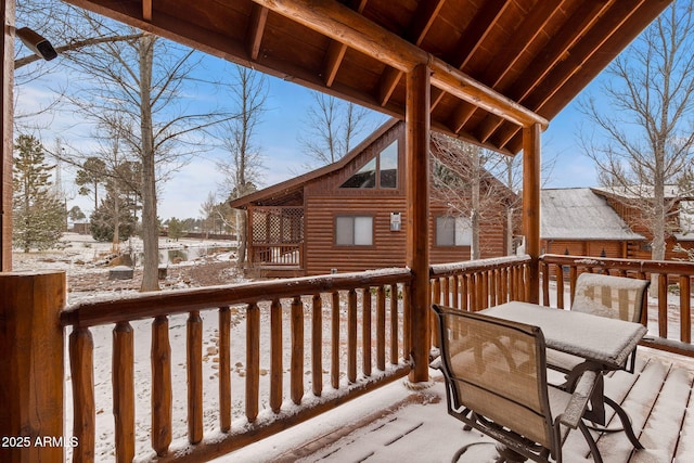 snow covered deck with outdoor dining area