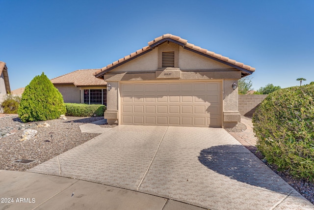 ranch-style house featuring a garage