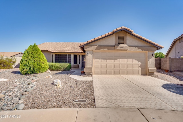 ranch-style home featuring a garage