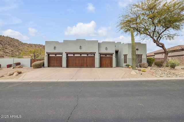 pueblo-style home featuring a mountain view and a garage