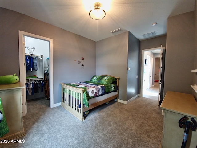 9187 W Parkside Ln, Peoria, AZ 85383 - bedroom featuring carpet, a walk in closet, a closet, and baseboards