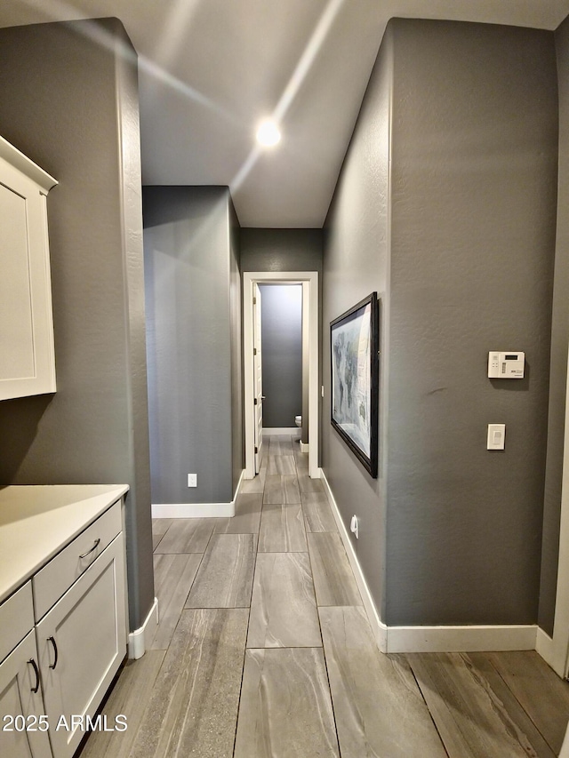 9187 W Parkside Ln, Peoria, AZ 85383 - hall with baseboards and vaulted ceiling