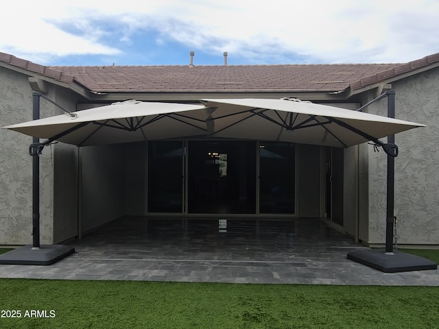 9187 W Parkside Ln, Peoria, AZ 85383 - back of house featuring a patio, stucco siding, a tile roof, and a yard