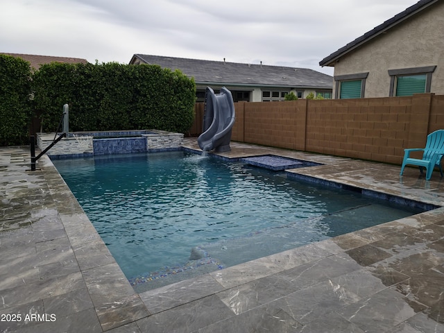 9187 W Parkside Ln, Peoria, AZ 85383 - view of swimming pool with a water slide, a fenced backyard, a patio, and a jacuzzi