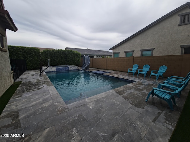 9187 W Parkside Ln, Peoria, AZ 85383 - view of swimming pool featuring a water slide, a fenced backyard, and a patio area