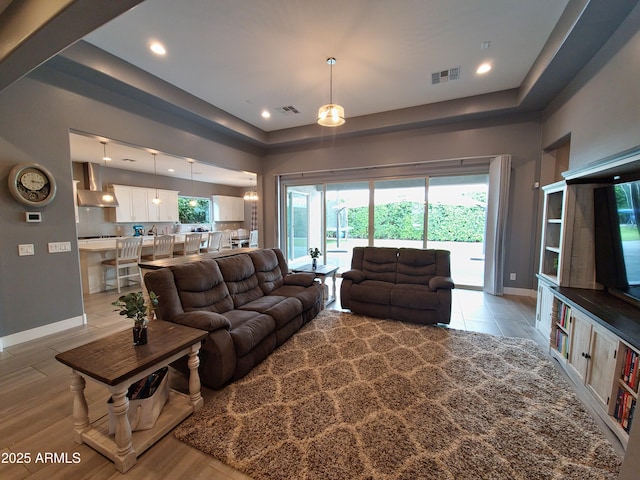 9187 W Parkside Ln, Peoria, AZ 85383 - living room featuring a tray ceiling, baseboards, and recessed lighting