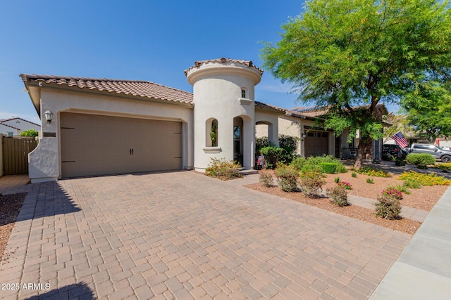 20556 W Point Ridge Rd, Buckeye, AZ 85396 - mediterranean / spanish home with an attached garage, stucco siding, a tiled roof, and decorative driveway