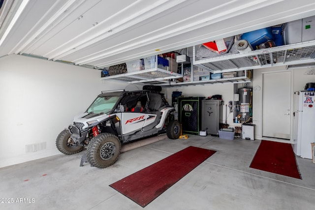 20556 W Point Ridge Rd, Buckeye, AZ 85396 - garage featuring gas water heater and freestanding refrigerator