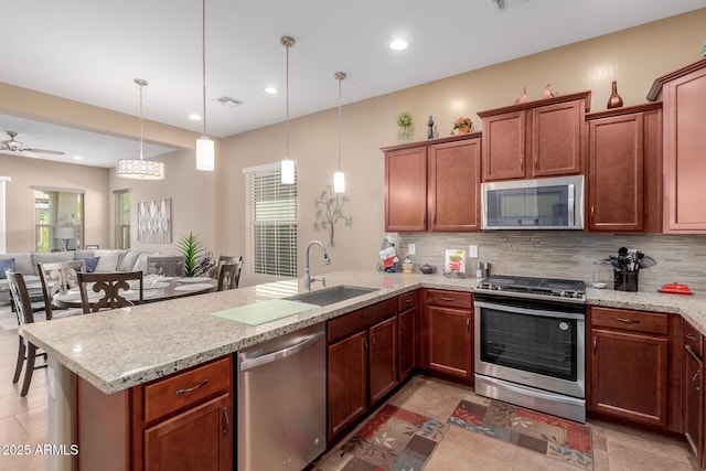 20556 W Point Ridge Rd, Buckeye, AZ 85396 - kitchen featuring appliances with stainless steel finishes, a peninsula, tasteful backsplash, a sink, and recessed lighting