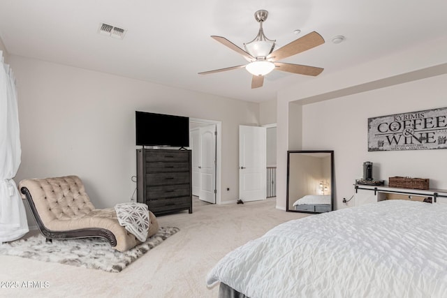 bedroom featuring visible vents, a ceiling fan, baseboards, and light colored carpet