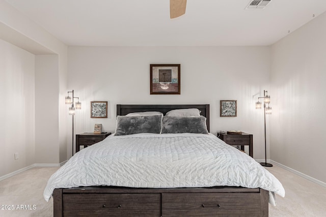 bedroom featuring visible vents, baseboards, and light carpet