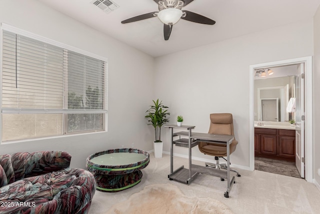 carpeted office space with a ceiling fan, baseboards, and visible vents
