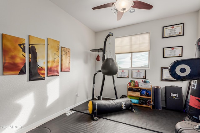 workout room with baseboards, a ceiling fan, and carpet flooring