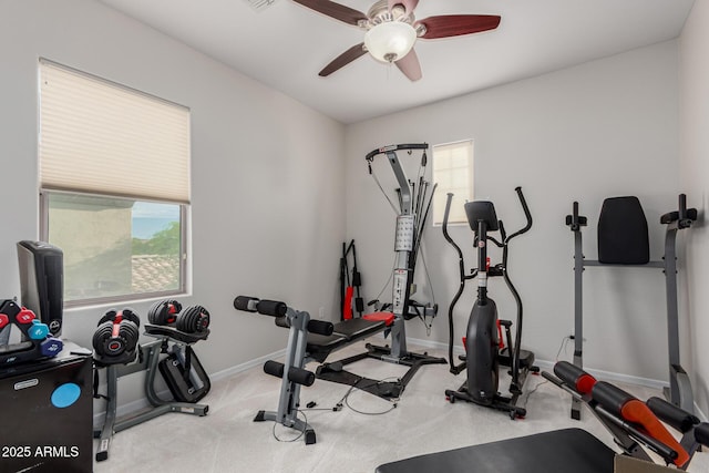 workout room featuring baseboards, a ceiling fan, and carpet