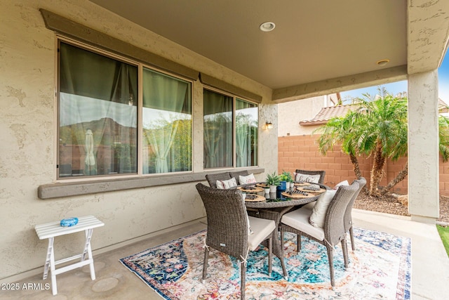 view of patio featuring fence and outdoor dining area