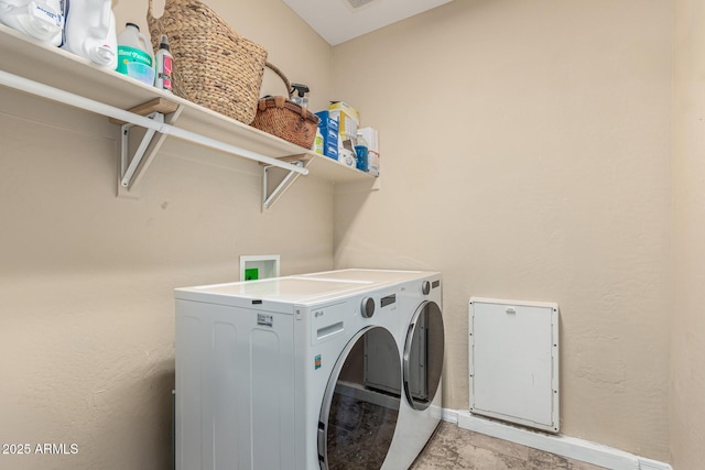 laundry area featuring laundry area, baseboards, and washing machine and dryer
