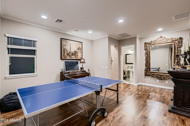 game room featuring recessed lighting, visible vents, wood finished floors, and ornamental molding