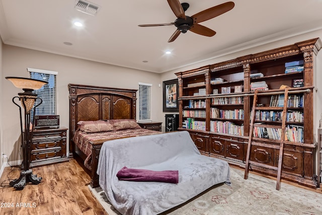 bedroom with crown molding, recessed lighting, wood finished floors, and visible vents